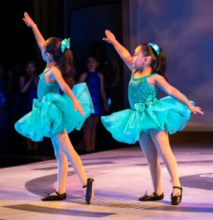 three ballet students pose